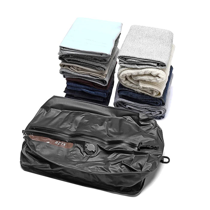Folded clothes next to the Auralane vacuum compression bag